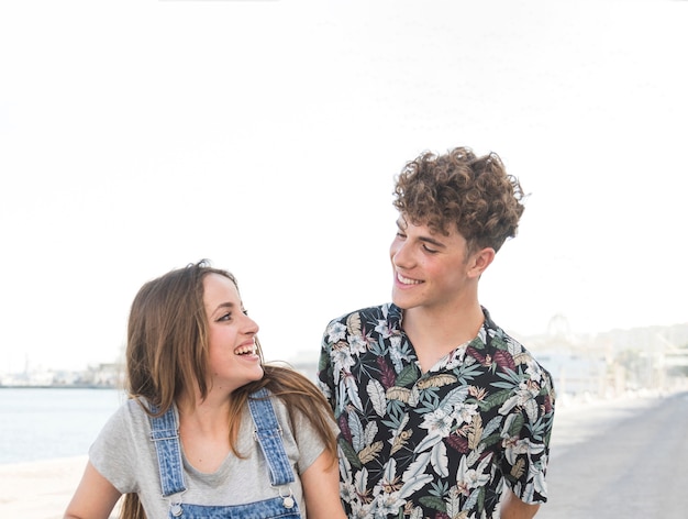 Smiling young couple looking at each other