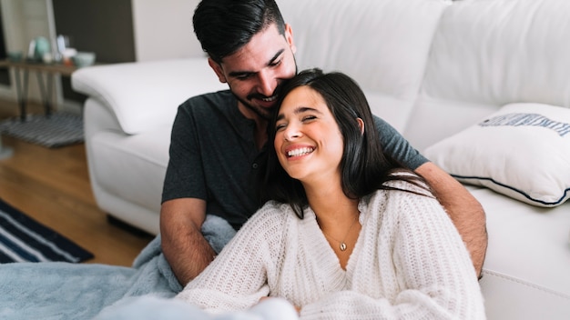 Smiling couple loving each other near the sofa | Photo: Freepik