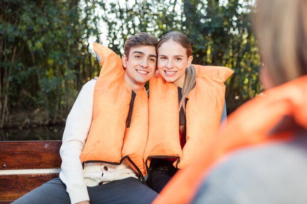 Smiling young couple with life jackets