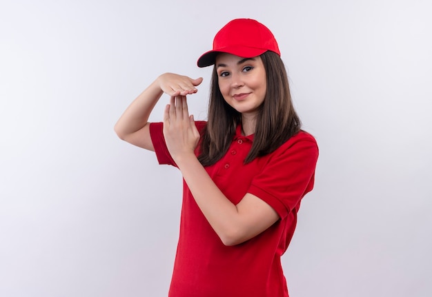 孤立した白い壁にタイムアウトを示す赤い帽子に赤いtシャツを着て笑顔の若い配達の女性