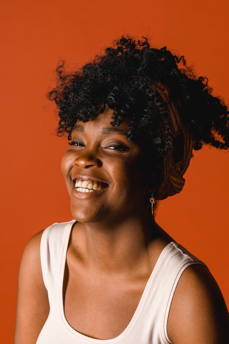 Free Photo smiling young ethnic female in t-shirt on colored background