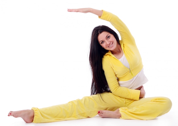 Smiling young girl doing fitness exercise