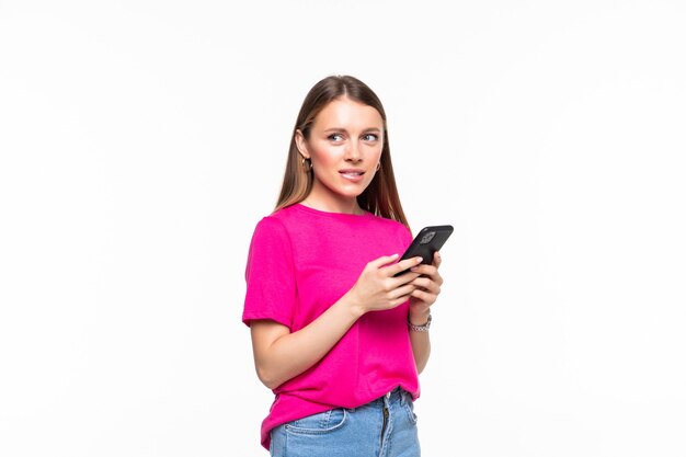 Smiling young girl text messaging on her mobile, isolated