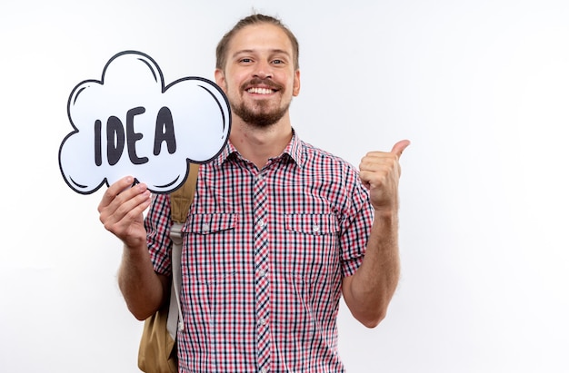 Free photo smiling young guy student wearing backpack holding idea bubble showing thumb up isolated on white wall