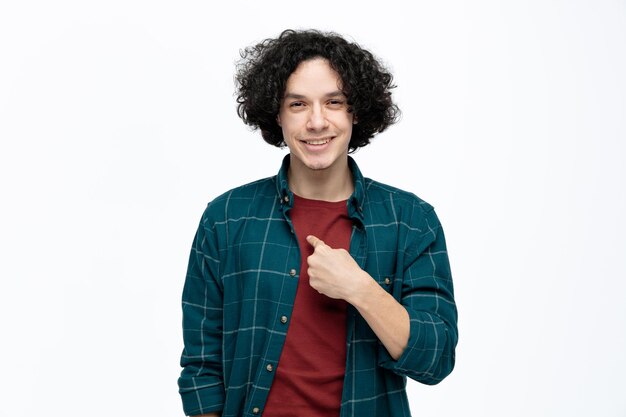 Smiling young handsome man looking at camera pointing at himself isolated on white background