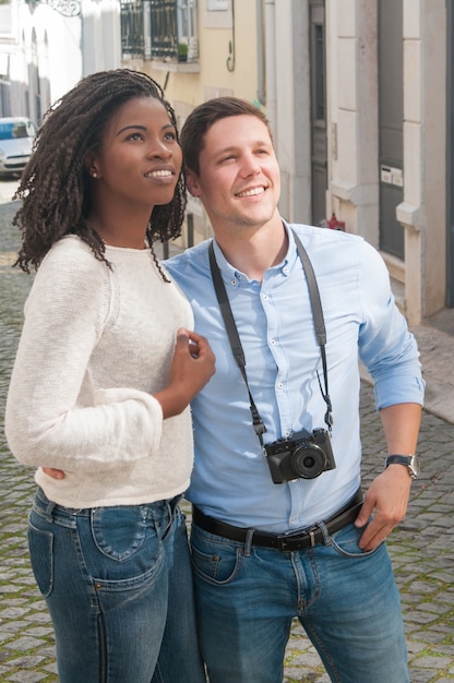 Smiling young interracial couple sightseeing outdoors