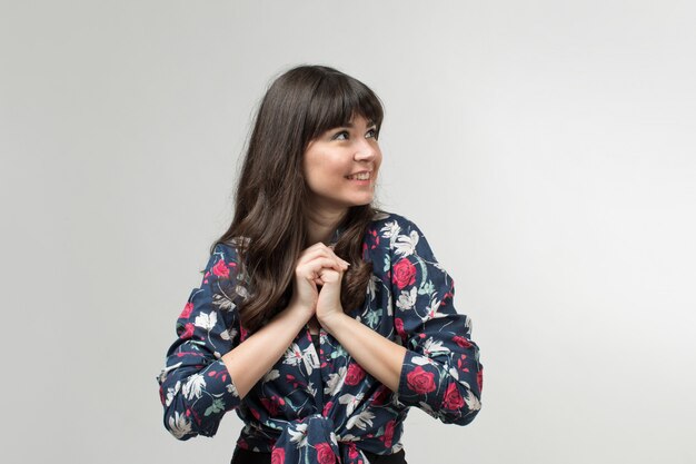 smiling young lady in designed t-shirt in good mood with long hair on white