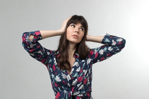 smiling young lady in designed t-shirt posing with long hair on white