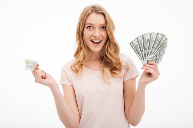 Free photo smiling young lady holding money and credit card.