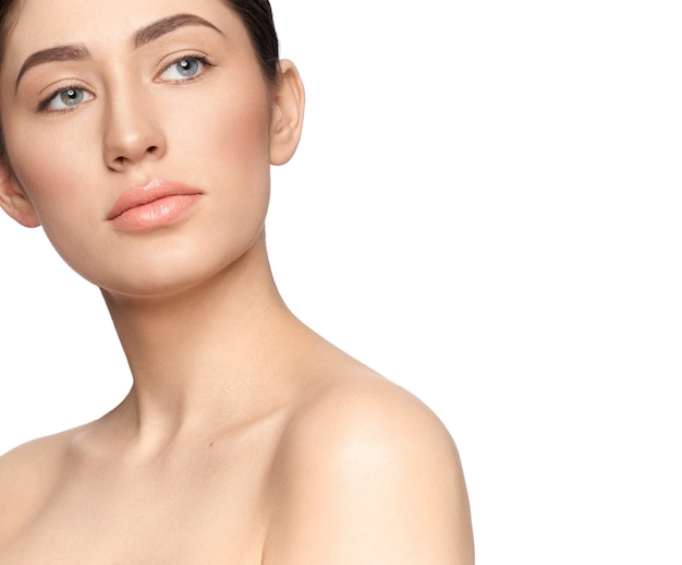 Smiling young lady without makeup looking aside in studio