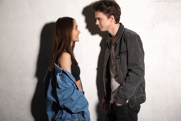 Smiling young loving couple looking aside