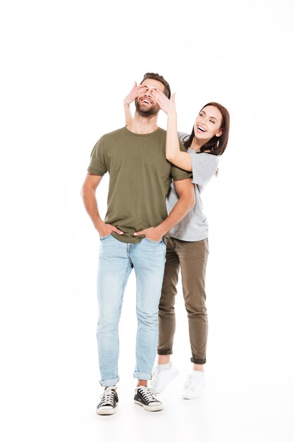 Smiling young loving couple standing isolated