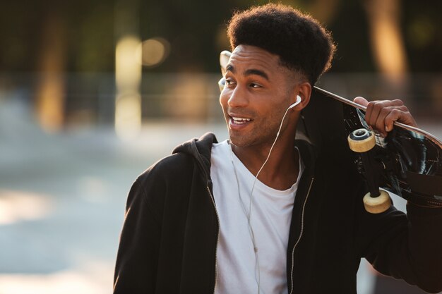 Smiling young male teenager guy with earphones