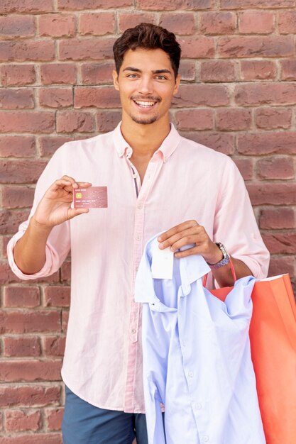 Smiling young man holding card