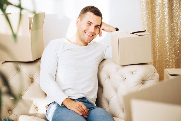 Smiling young man posing in new house