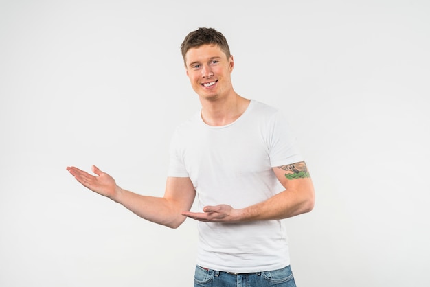 Smiling young man presenting isolated on white background