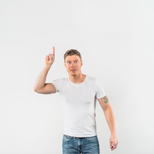 Smiling young man showing number one isolated on white backdrop