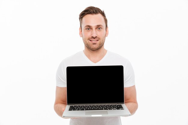 Smiling young man standing isolated