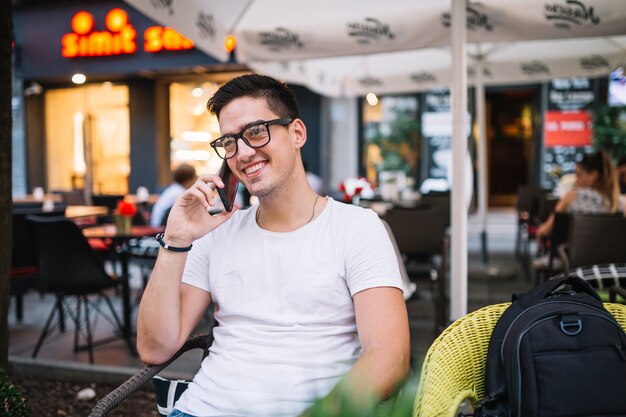 Smiling young man talking on mobile phone