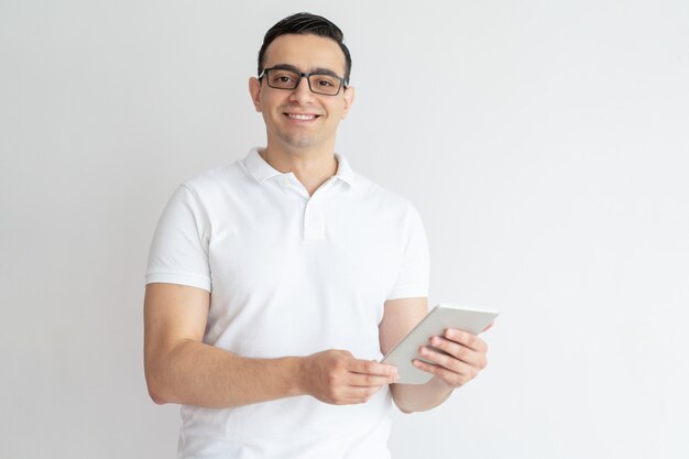 Smiling young man using tablet computer