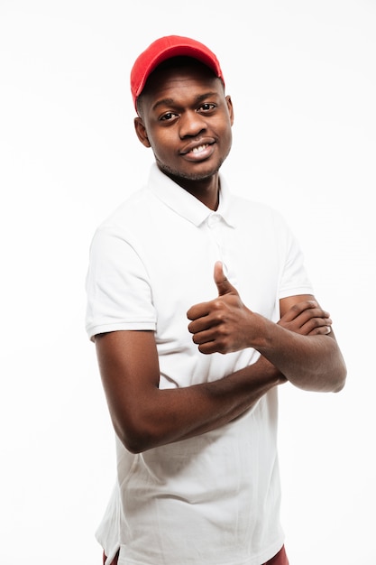 Smiling young man wearing cap make thumbs up gesture