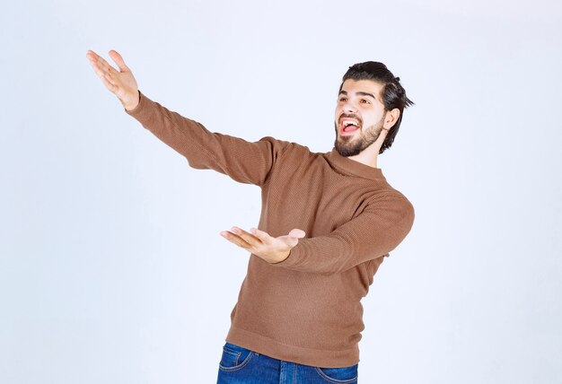 smiling young man welcoming and walking forward