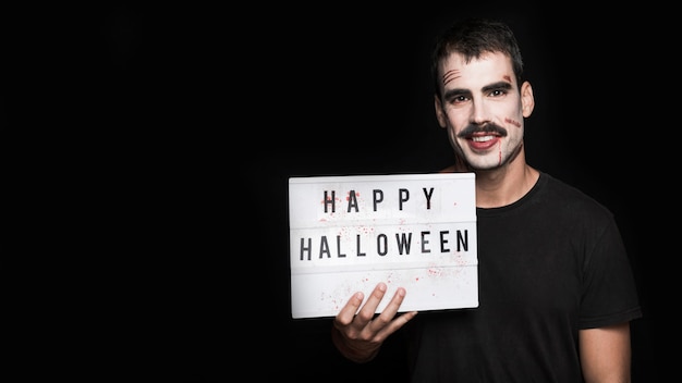 Free photo smiling young man with signboard