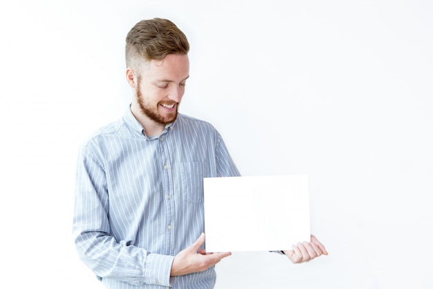 Free photo smiling young manager demonstrating advertisement