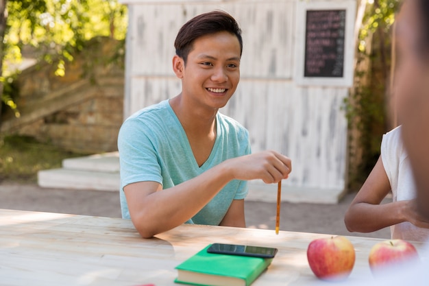 Smiling young multiethnic group of friends students talking