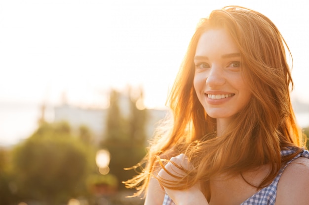 Smiling young redhead woman with long hair