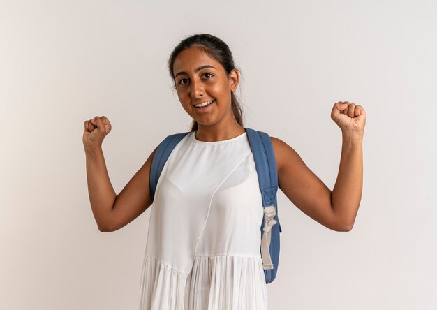 Free photo smiling young schoolgirl wearing back bag showing yes gesture on white