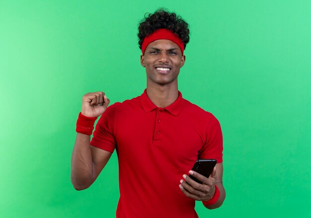 Smiling young sporty man wearing headband