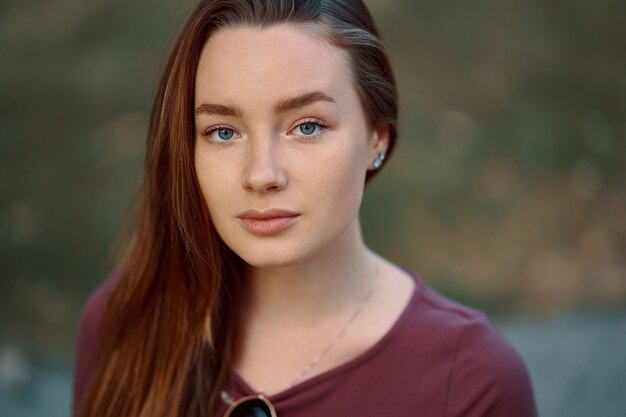 Smiling young woman closeup portrait outdoors