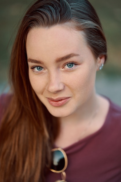 Smiling young woman closeup portrait outdoors