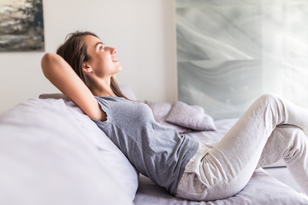 Smiling young woman relax lying on couch