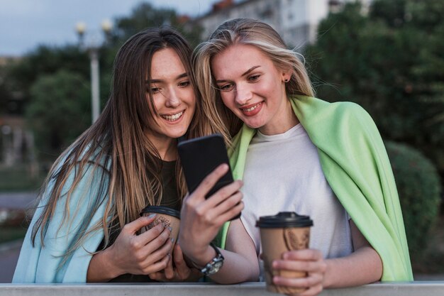 笑顔の若い女性が写真を撮る