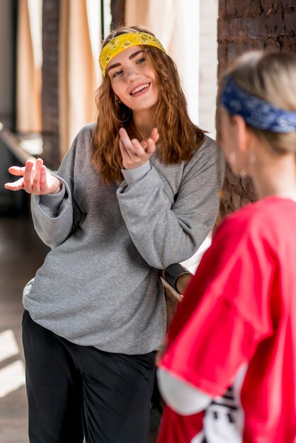 Smiling young woman talking with her friend