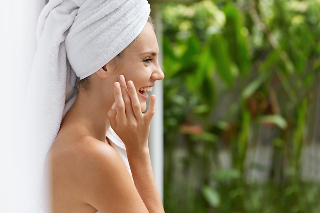 Smiling young woman in towels