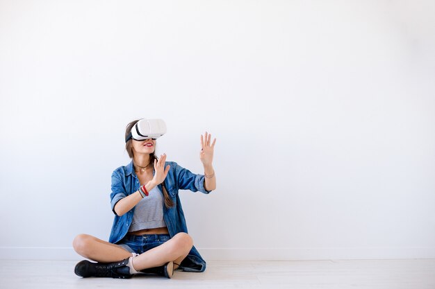 Smiling young woman use VR glasses