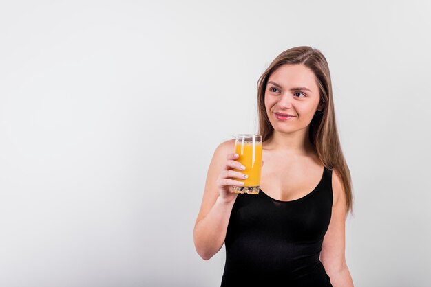 Smiling young woman with glass of juice
