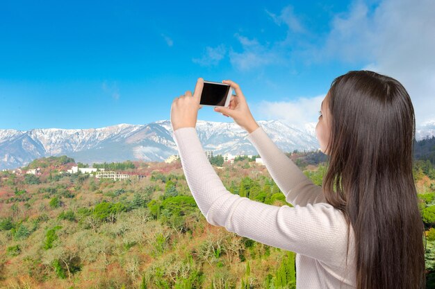 Smiling young woman with mobile phone