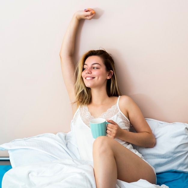 Free photo smilling woman laying in bed and looking away