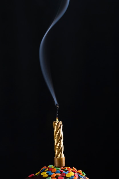 Smoke rising out of blown candle