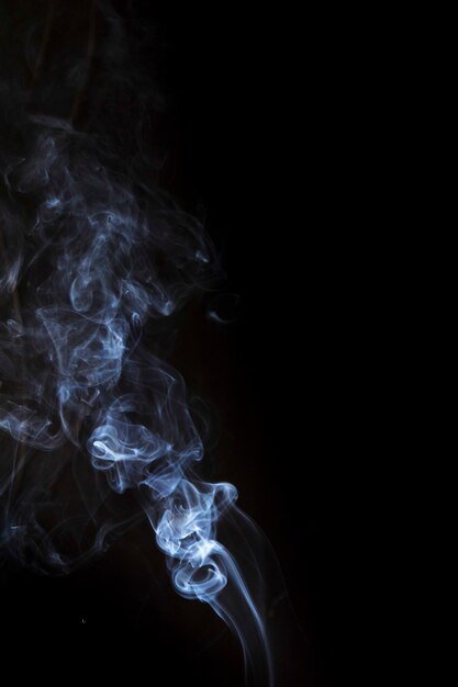 Smoke swirling around against a black background