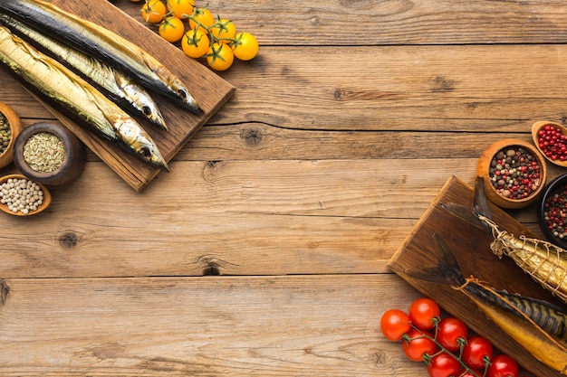 Smoked fishes on wooden table top view