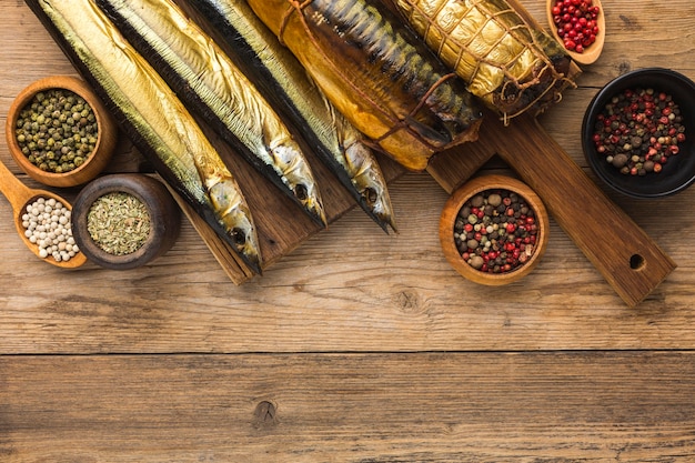 Smoked fishes on wooden table above view