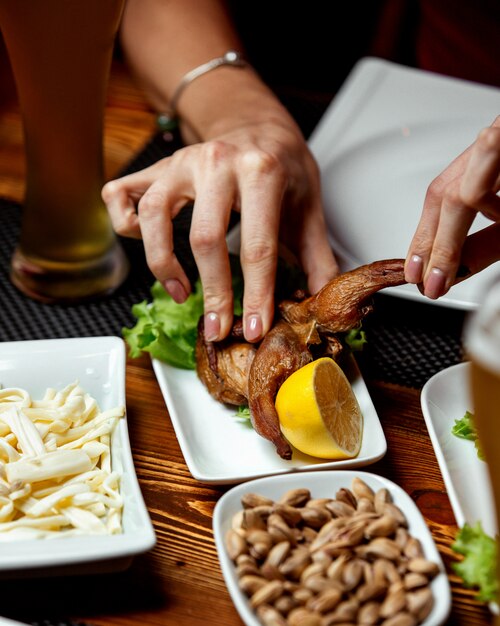 Smoked quail served with lemon