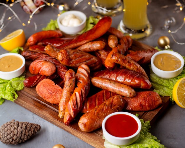 Smoked sausages served with ketchup, mustard, mayonnaise and lemon