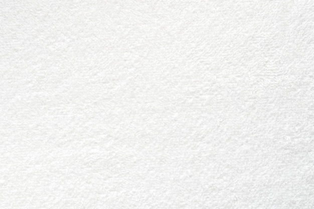 Smooth white towel, close-up of soft towel as texture or background, top view