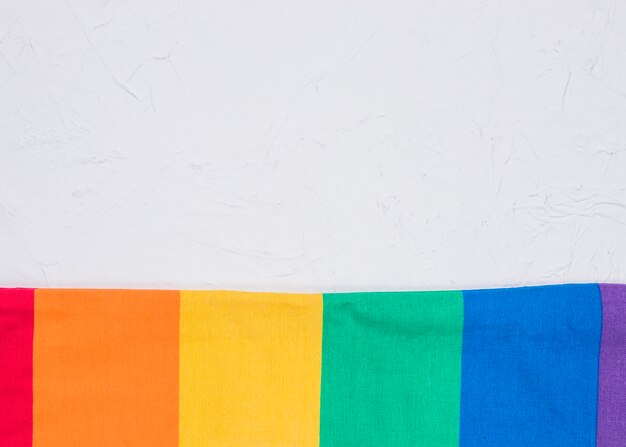 Smoothed LGBT flag on white surface